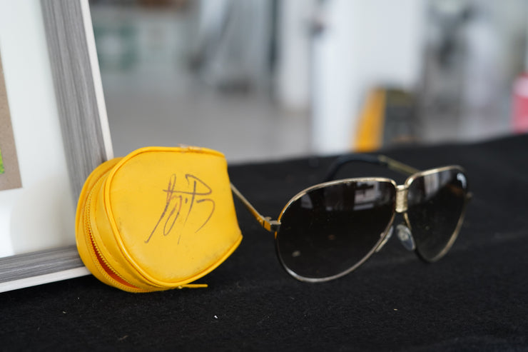 1985 Ayrton Senna personal Camel sunglasses with signed glass holder