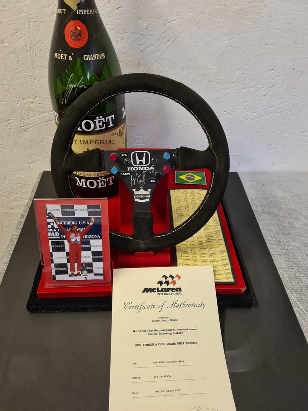 Replica Set: 1991 Ayrton Senna Steering Wheel and Podium Champagne Bottle